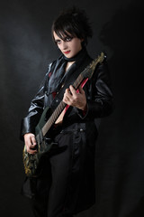 Fototapeta na wymiar Romantic gothic boy playing guitar