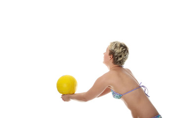 Teen woman in bikini playing volleyball