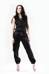 Slim young woman dressed in black trousers