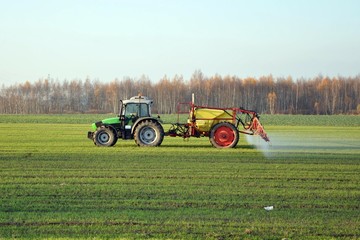 Tractor working on a field in autumn season