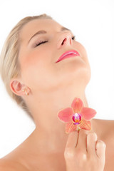 Young healthy woman with beautiful pure skin and flower