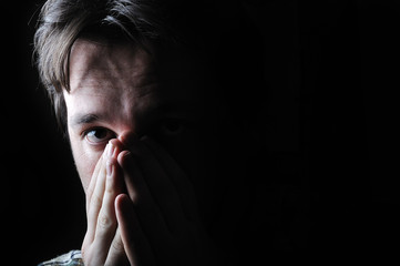 Young man in the dark