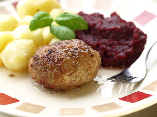 Homemade meatballs dinner with potatoes and cooked beetroots.
