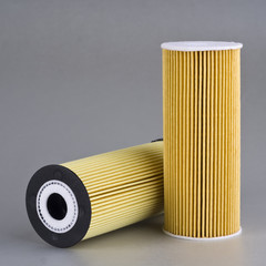 two gasoline filters on gray industrial background