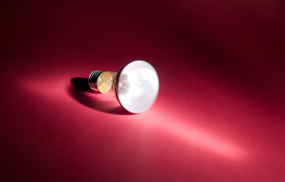 Electric bulb on red background