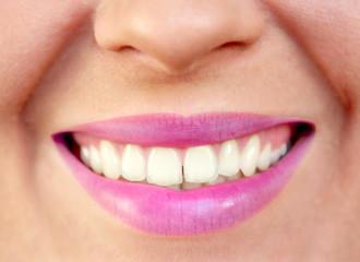 Closeup of smiling young woman mouth teeth