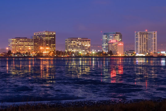 Buildings reflecting in the water at night
