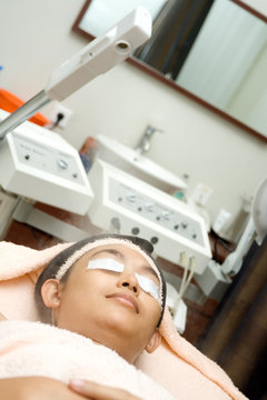 Woman Having Facial Treatment Using Herbal Steamer