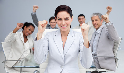 Happy business people celebrating a sucess with hands up