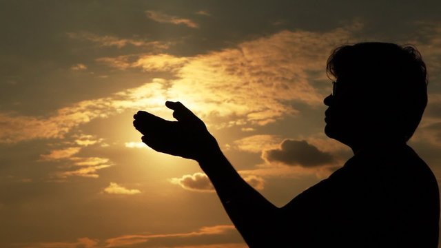 man takes the sun in hands