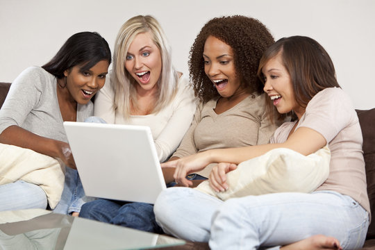 Four Interracial Female Friends Laughing and Looking at Laptop C
