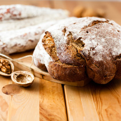 Rustic loaf of bread and salami in the background