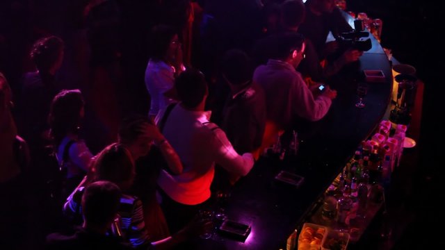 People at bar rack in night club