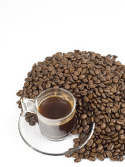 glass cup of turkish coffee with coffee beans around