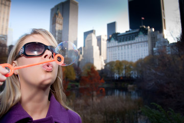 Young Woman Playing with Bubbles in Cental Park NYC