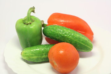 Fresh vegetables: two pepper, tomato and two cucumber