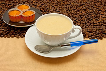 White cup of coffee and coffee beans