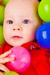 Obraz premium Infant with colorful balls