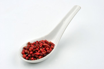 red organic pepper and a white background