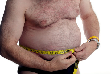 Over weight man measuring his stomach