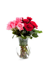 pink and red roses in a clear vase on white