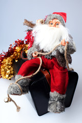 Santa on a bag with gifts isolated