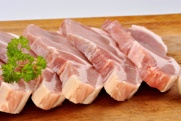 some raw organic pork chop and parsley