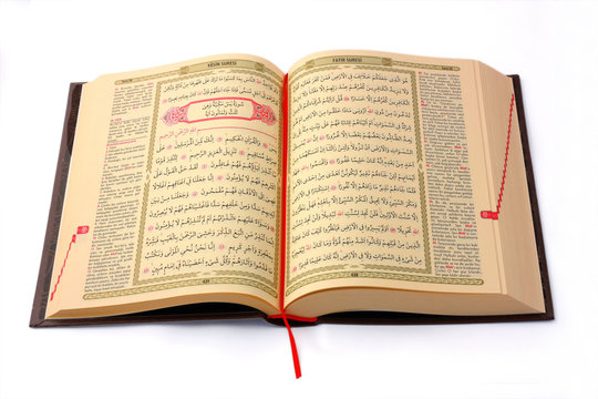 The Holy Koran opened and isolated on white background