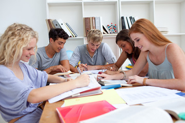 Teenagers doing homework in the library