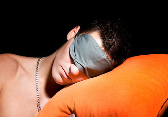 Young man sleeping with sleepping glasses