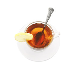 Transparent cup of tea with spoon and lemon isolated on white
