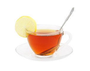 Transparent cup of tea with spoon and lemon isolated on white