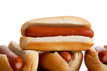 Stacked hot dogs and buns on white