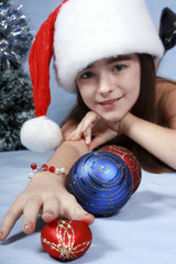 Fototapeta na wymiar Girl in a cap with the Christmas decorations.