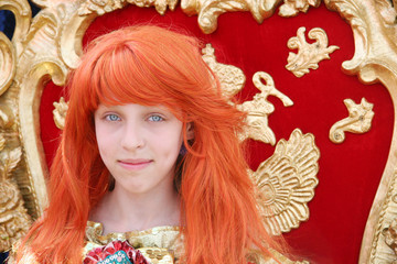 Red-haired teenage girl wearing an antique princess dress