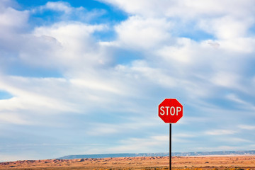 Stop Sign against a Dramatic Sky in the Desert.