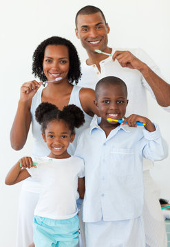 Smiling Family Brushing Their Teeth