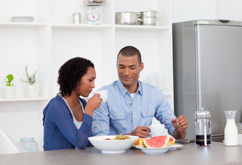 Smiling couple having breakfast together