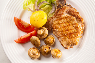 Grilled meat with boiled potatoes and vegetable salad