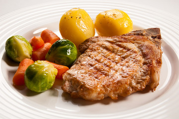 Grilled meat with boiled potatoes and vegetable salad