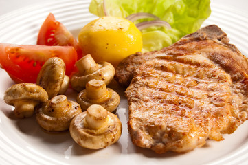 Grilled meat with boiled potatoes and vegetable salad