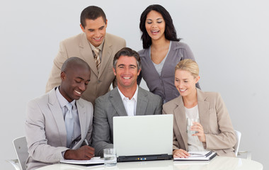 Smiling multi-ethnic business team working in office together