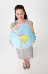 Fototapeta premium Beautiful businesswoman holding a terrestrial globe