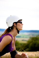 Young woman on rollerblades in the country