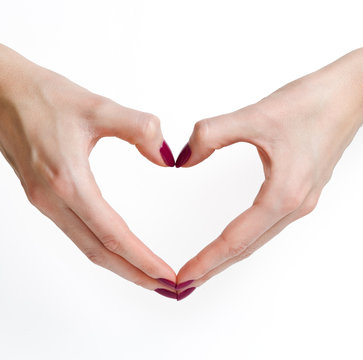 Woman hands with manicure in heart shape
