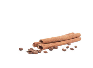 Cinnamon and coffee beans over white background