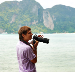 Funny photographer on the beach