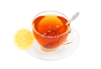 Transparent cup of tea with spoon and lemon isolated