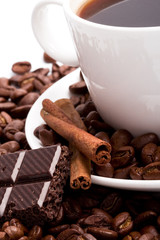 cup of coffee, beans, cinnamon and black chocolate