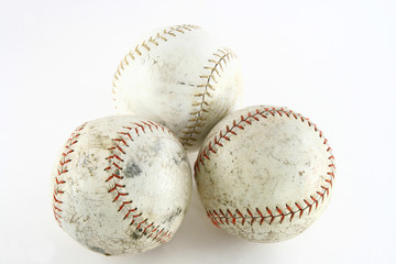 3 worn used softballs